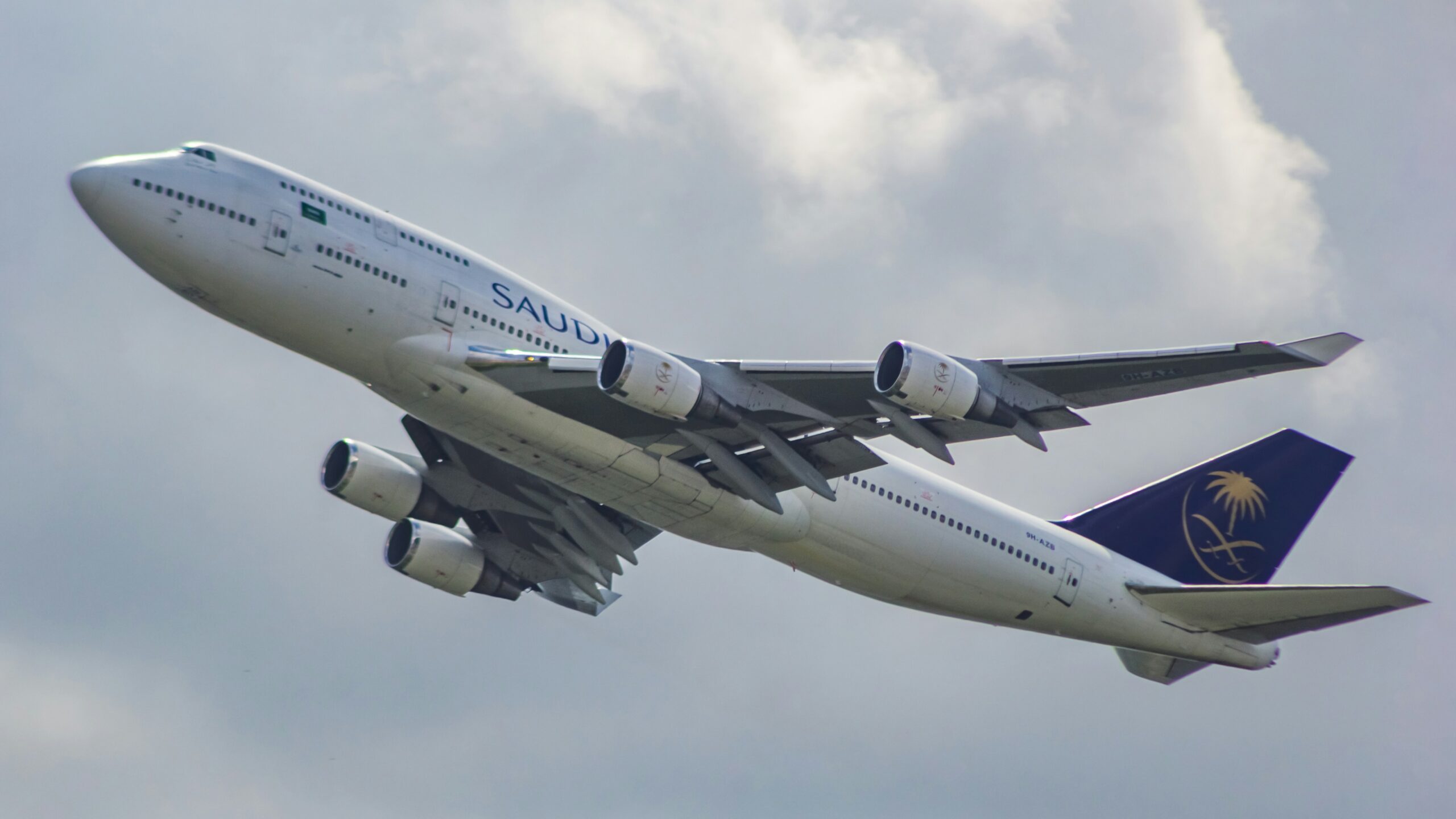 A large jetliner flying through a cloudy sky