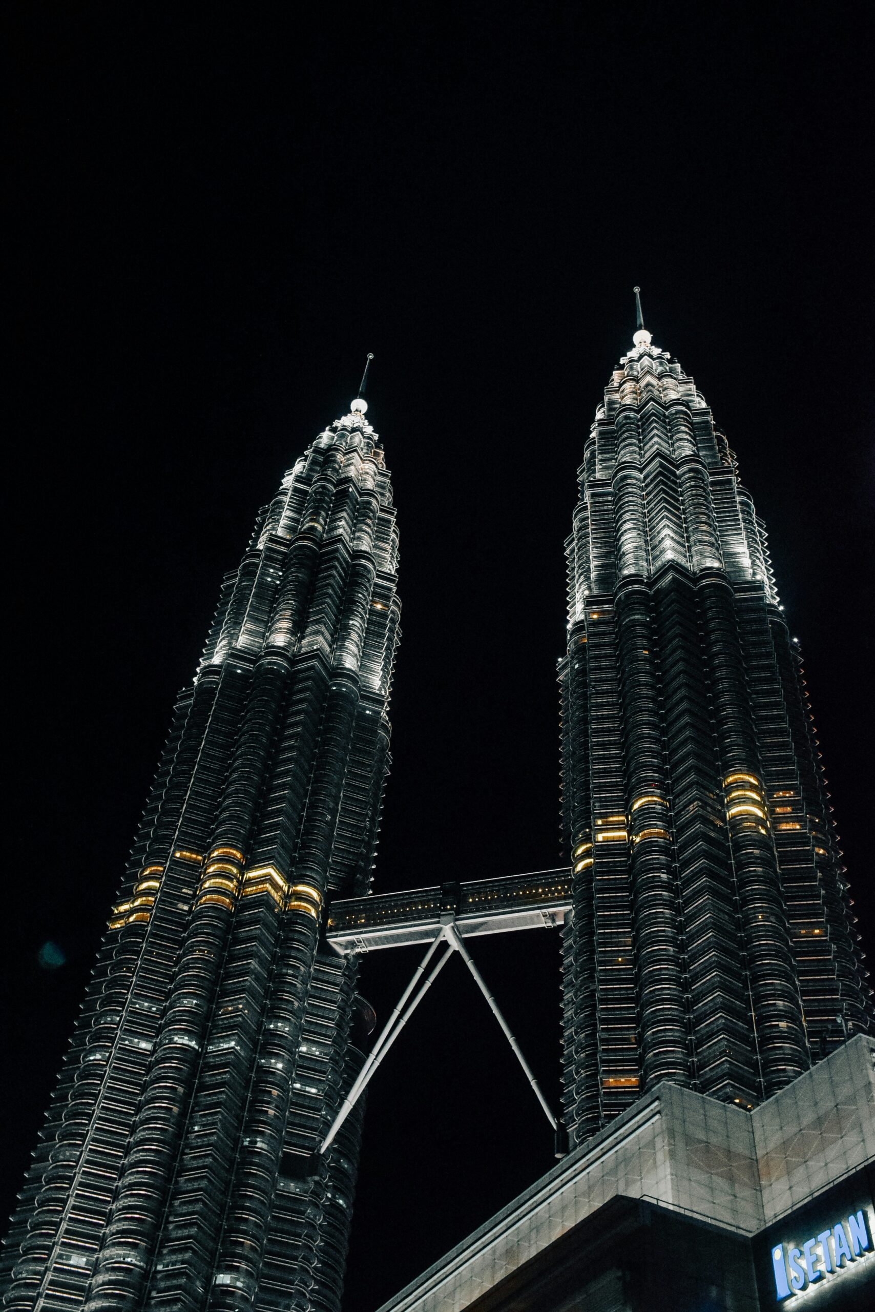 a couple of very tall buildings in the dark