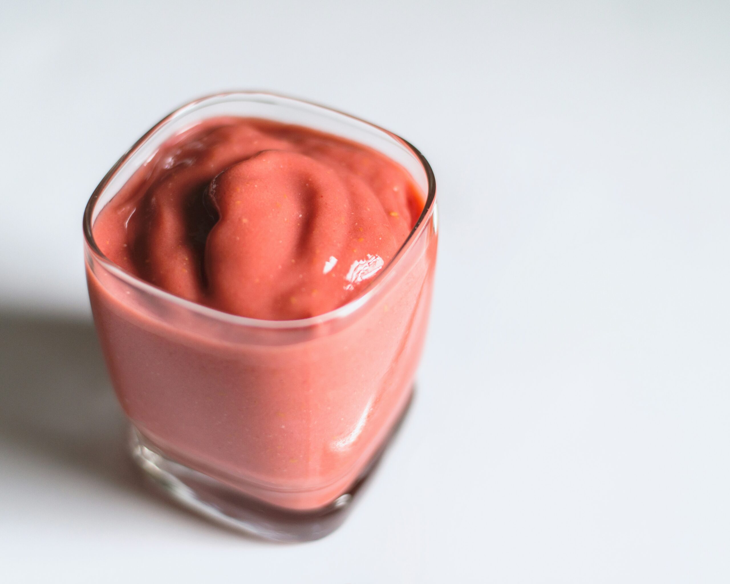 clear glass cup with pink cream